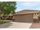 Charming single-story home featuring a well-manicured lawn, desert landscaping, and a two-car garage at 1114 N Leland Ct, Gilbert, AZ 85233