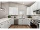 Stylish kitchen features white cabinets, stainless appliances, and modern backsplash at 1114 N Leland Ct, Gilbert, AZ 85233
