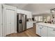 The kitchen features stainless steel refrigerator, white cabinets, and breakfast bar at 1114 N Leland Ct, Gilbert, AZ 85233