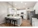 Bright, open kitchen features white cabinets, stainless appliances, breakfast bar and wood floors at 1114 N Leland Ct, Gilbert, AZ 85233