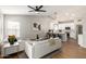 Open-concept living area with sleek white sofas and accents open to bright modern kitchen with breakfast bar at 1114 N Leland Ct, Gilbert, AZ 85233