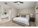 This main bedroom features an ensuite bathroom, neutral tones and soft carpet at 1114 N Leland Ct, Gilbert, AZ 85233