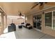 Relaxing covered patio features comfortable seating, ceiling fans, and a sliding glass door at 1114 N Leland Ct, Gilbert, AZ 85233