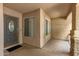 Inviting covered front porch with decorative front door, stone column and neutral walls at 1114 N Leland Ct, Gilbert, AZ 85233