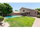 Spacious backyard with green grass and a refreshing pool at 113 N Albert Dr, Chandler, AZ 85226