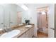 Bathroom featuring a double sink vanity with granite countertops, and a shower/tub combo at 113 N Albert Dr, Chandler, AZ 85226
