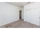 Simple carpeted bedroom with neutral paint and a closet with sliding doors at 113 N Albert Dr, Chandler, AZ 85226