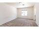 Bedroom showcasing a window and neutral colored walls with carpeting at 113 N Albert Dr, Chandler, AZ 85226