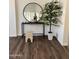 Light-filled entryway features modern decor with wood floors, a sleek console table, and circular mirror at 113 N Albert Dr, Chandler, AZ 85226