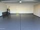 Spacious garage features epoxy flooring, storage cabinets, and modern water heater at 113 N Albert Dr, Chandler, AZ 85226