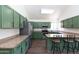 Stylish kitchen with stainless steel appliances, center island seating, and hardwood floors at 113 N Albert Dr, Chandler, AZ 85226