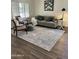 Cozy living room features wood floors, natural light, and a comfortable seating area at 113 N Albert Dr, Chandler, AZ 85226