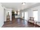 Open living area with wood floors seamlessly connecting to the kitchen and other spaces at 113 N Albert Dr, Chandler, AZ 85226