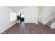 Open-concept living area featuring sleek floors, neutral walls, and staircase at 113 N Albert Dr, Chandler, AZ 85226