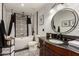 Modern bathroom featuring a soaking tub, dark vanity, and patterned tile at 12866 W Orange Dr, Litchfield Park, AZ 85340
