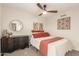 Bedroom featuring a comfortable bed, ceiling fan, and decorative artwork at 12866 W Orange Dr, Litchfield Park, AZ 85340
