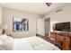 Bedroom with a bed, window, and modern entertainment center at 12866 W Orange Dr, Litchfield Park, AZ 85340