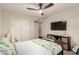 Comfortable bedroom with ceiling fan, closet, and media console at 12866 W Orange Dr, Litchfield Park, AZ 85340