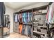 Organized closet with wooden shelves, clothing racks, and shoe storage at 12866 W Orange Dr, Litchfield Park, AZ 85340