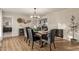Elegant dining room features a stylish chandelier, modern decor, and an adjacent fireplace at 12866 W Orange Dr, Litchfield Park, AZ 85340