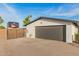 Garage exterior with a dark gray door and an RV parked alongside at 12866 W Orange Dr, Litchfield Park, AZ 85340