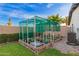 A covered garden includes four raised garden beds filled with plants at 12866 W Orange Dr, Litchfield Park, AZ 85340