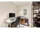 Functional home office space with desk, shelves, storage cabinets, and natural light at 12866 W Orange Dr, Litchfield Park, AZ 85340