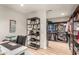 Well organized home office with desk, shelves, storage cabinets, and a closet with clothes at 12866 W Orange Dr, Litchfield Park, AZ 85340