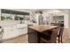 Modern kitchen with a large window, farmhouse sink, stainless steel appliances, and breakfast bar at 12866 W Orange Dr, Litchfield Park, AZ 85340