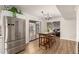 Kitchen with eat-in dining area showcases stainless steel appliances, bar stool seating, and backyard access at 12866 W Orange Dr, Litchfield Park, AZ 85340