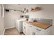 Well-organized laundry room with wood countertops and modern appliances at 12866 W Orange Dr, Litchfield Park, AZ 85340