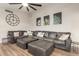 Spacious living room features a large sectional sofa, hardwood floors, and modern decor at 12866 W Orange Dr, Litchfield Park, AZ 85340