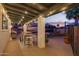 Covered patio with string lights, outdoor kitchen, and shaded seating at 12866 W Orange Dr, Litchfield Park, AZ 85340
