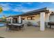 Covered patio featuring dining table, BBQ, exterior television and swing at 12866 W Orange Dr, Litchfield Park, AZ 85340
