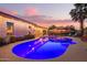 Inviting backyard featuring a private pool, outdoor lighting, and a spacious patio perfect for entertaining at 12866 W Orange Dr, Litchfield Park, AZ 85340