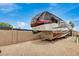 Shot of an RV parked in a fenced yard with gravel; the RV is a luxury model with modern design at 12866 W Orange Dr, Litchfield Park, AZ 85340