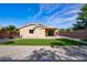 View of the backyard featuring a patch of artificial turf and gravel landscaping at 13170 W Clarendon Ave, Litchfield Park, AZ 85340