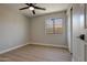 Bedroom showcasing wood-look floors, a ceiling fan, and a window letting in natural light at 13170 W Clarendon Ave, Litchfield Park, AZ 85340