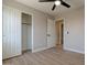 A bedroom featuring wood-look tile, closet and view to bathroom at 13170 W Clarendon Ave, Litchfield Park, AZ 85340