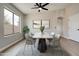 Bright dining room featuring modern table, stylish chairs, hardwood floors, and neutral decor, creating an elegant space at 13170 W Clarendon Ave, Litchfield Park, AZ 85340