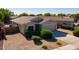 Charming single-story home featuring a tile roof, low-maintenance landscaping, and an attached two-car garage at 13170 W Clarendon Ave, Litchfield Park, AZ 85340