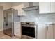 Modern kitchen featuring stainless steel appliances, gray subway tile backsplash, and quartz countertops at 13170 W Clarendon Ave, Litchfield Park, AZ 85340
