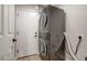 This laundry room is equipped with a stacked washer and dryer unit for convenience at 13170 W Clarendon Ave, Litchfield Park, AZ 85340