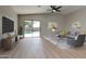 Spacious living room with sliding glass doors to backyard, featuring modern decor and neutral tones at 13170 W Clarendon Ave, Litchfield Park, AZ 85340