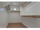 Walk-in closet featuring wooden racks and tile floors at 13170 W Clarendon Ave, Litchfield Park, AZ 85340