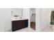 Bathroom featuring a double vanity with granite countertop, and walk-in closet at 1359 S Vista Ave, Florence, AZ 85132