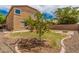 Backyard oasis featuring grass, rock landscaping, a fruit tree, and privacy wall at 15551 W Poinsettia Dr, Surprise, AZ 85379