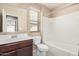 Bathroom featuring a single sink vanity, a toilet, and a shower with a tub at 15551 W Poinsettia Dr, Surprise, AZ 85379