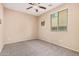 Neutral bedroom offers a ceiling fan, a window for natural light and carpeted floors at 15551 W Poinsettia Dr, Surprise, AZ 85379