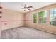 Bedroom has large windows with blinds and a ceiling fan to keep it cool at 15551 W Poinsettia Dr, Surprise, AZ 85379